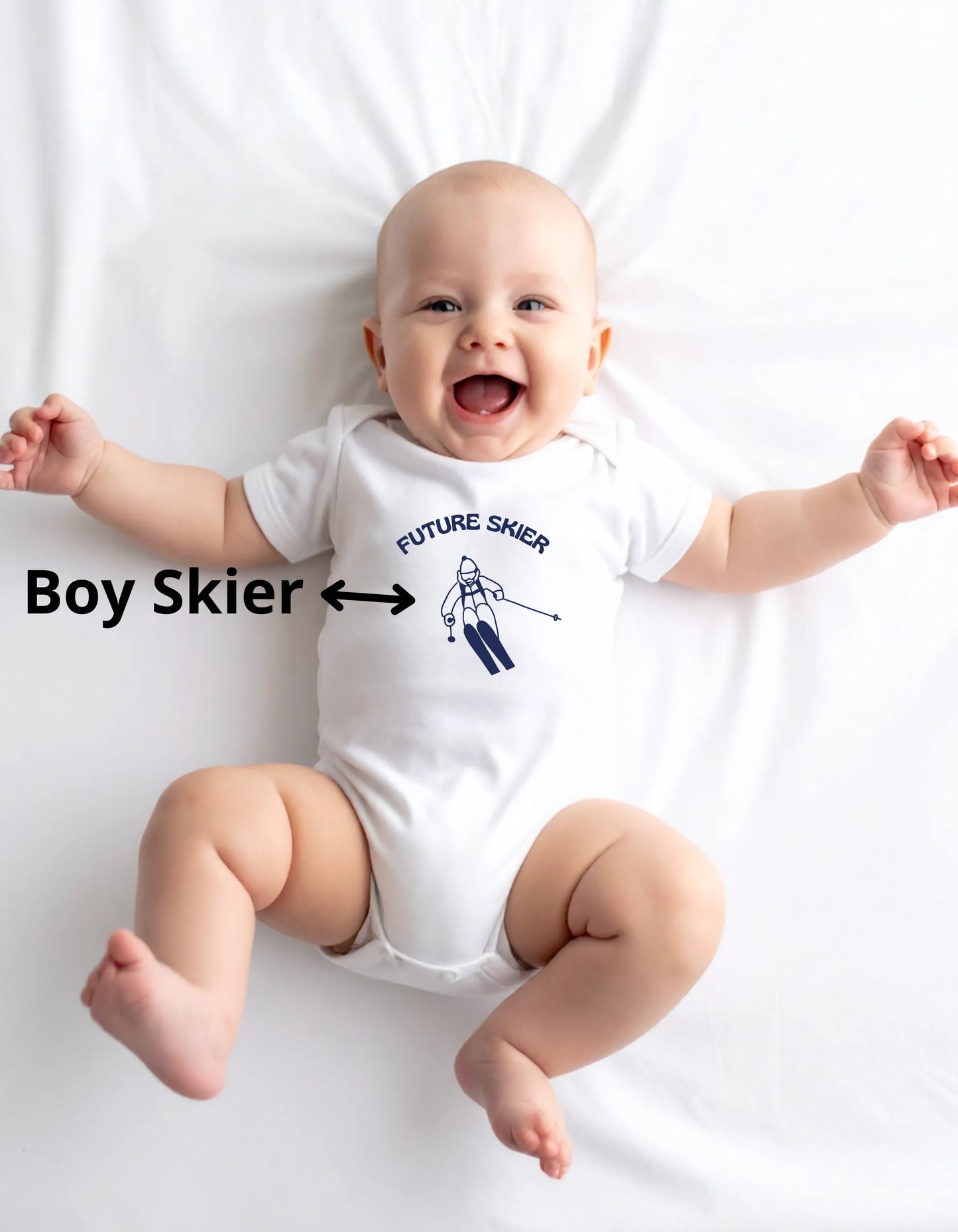 Baby wearing a white onesie with 'Future Skier' text and ski motif