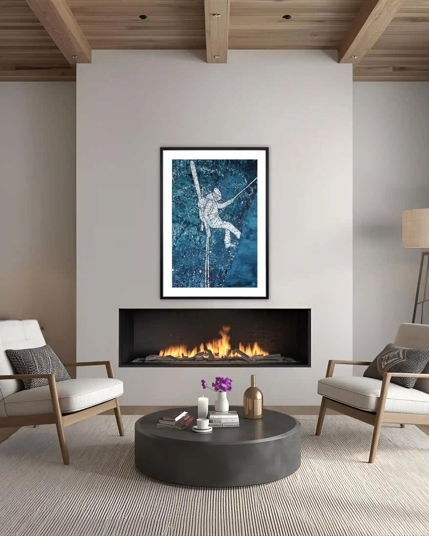 Modern living room with a fireplace, chairs, and a framed ski artwork on the wall.
